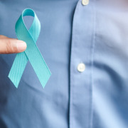 Amethyst Radiotherapy - Man holding light Blue Ribbon