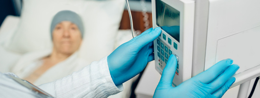 Private chemotherapy treatment - Oncologist turning on device IV drip chemotherapy