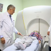 gamma knife treatment - Two doctors prepares the patient for the procedure on the Gamma Knife